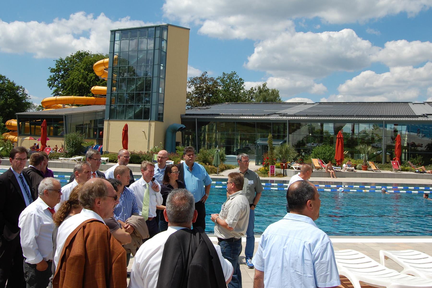 Group of conference delegates visiting outdoor pool