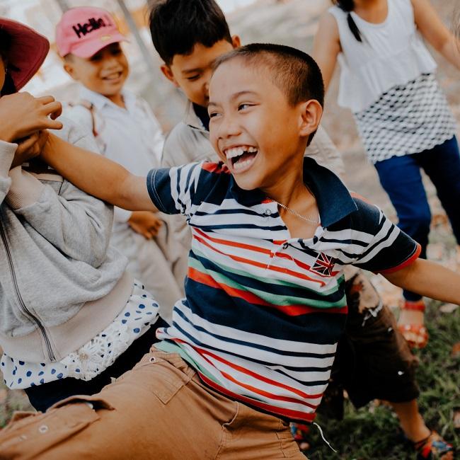 Children playing on grass field_UNSPLASH_mi-pham.jpg