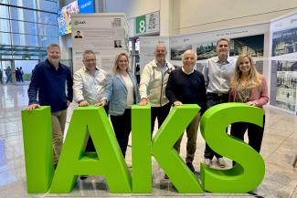 IAKS members cheering with an IAKS logo