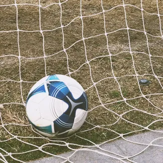 ball lying in net 6TL-WevCdgk-unsplash_brandi-ibrao 