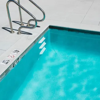 blue swimming pool with ladder vy_cVJCAVG0-unsplash-milkovi_650.