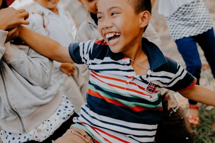 Children playing on grass field_UNSPLASH_mi-pham.jpg