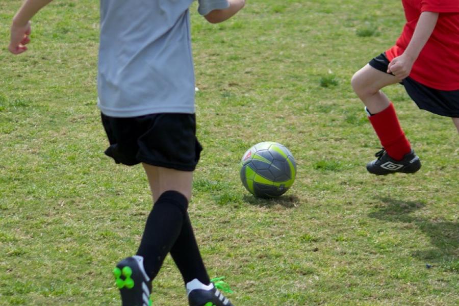 two people playing soccer on grass field 650-0axqBrI8Or4-unsplash james-lee_.jpg