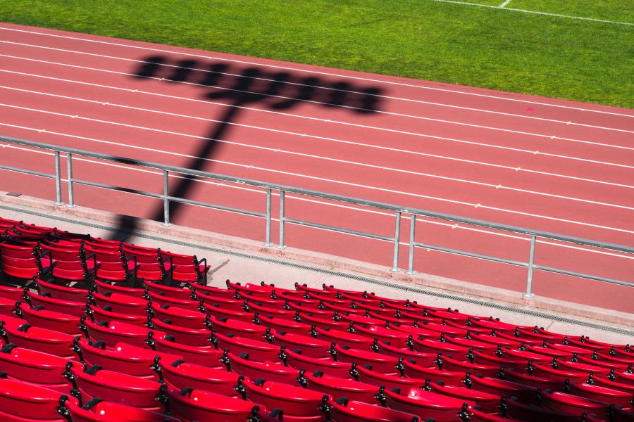 View into sport stadium with the seats, the track and some grass