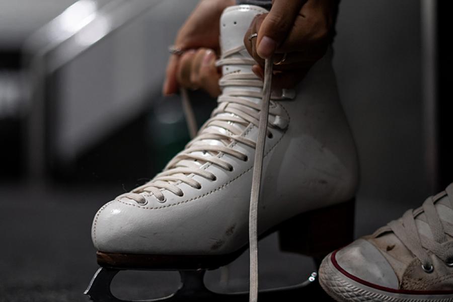 Girl putting on ice skates